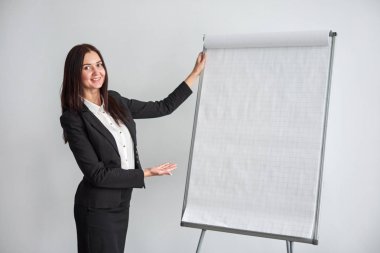 flipchart Office tarafından duran genç gülümseyen iş kadını portresi