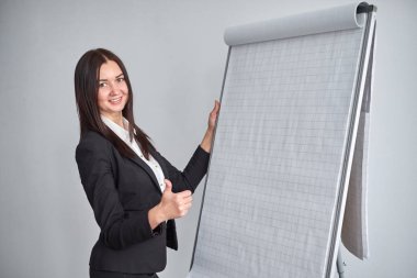 flipchart Office tarafından duran genç gülümseyen iş kadını portresi