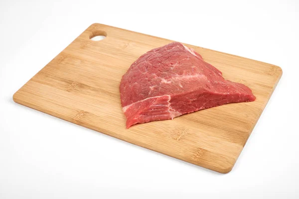 Fresh raw beef on a cutting board isolated on white background — Stock Photo, Image
