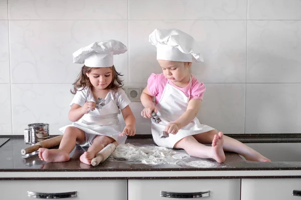 Two Little girl preparing cookies in kitchen at home — Stock Photo, Image