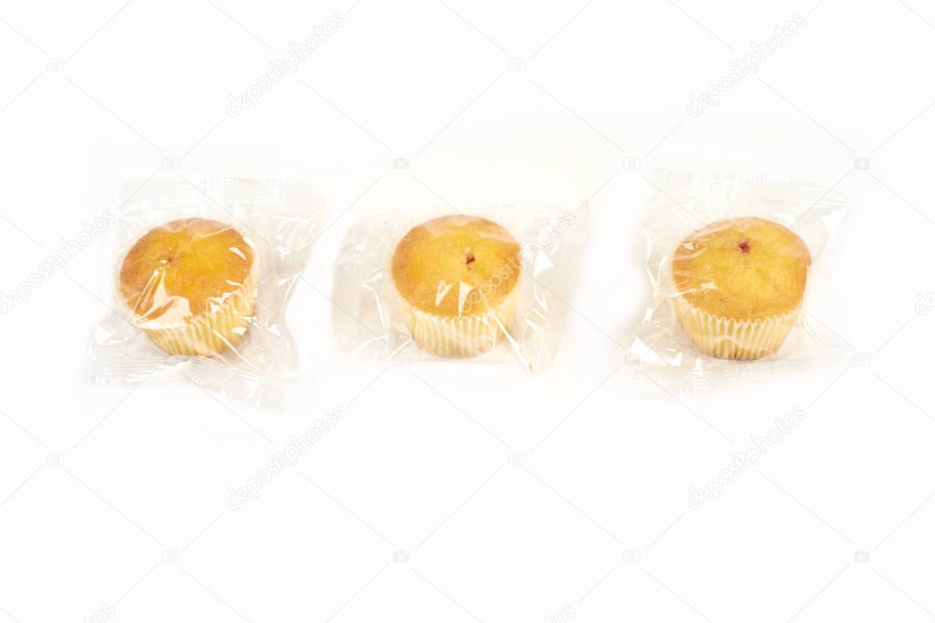 muffins packed in transparent packaging, on a white background.