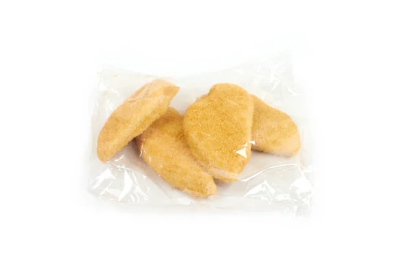 Fried chicken breast in a transparent packageon white background. — Stock Photo, Image