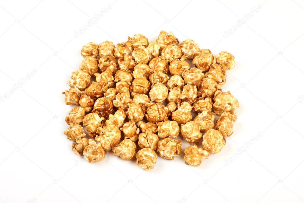Pile of caramel popcorn on white background.