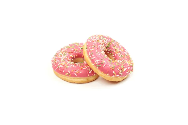 Rosado donut con coloridos espolvoreos aislados sobre fondo blanco. — Foto de Stock