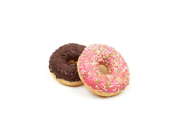 Lekkere chocolade donut en roze donut met kleurrijke hagelslag op witte achtergrond — Stockfoto