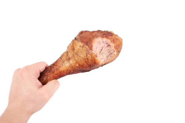 Hand holding roasted chicken leg with bite taken , isolated on white background. — Stock Photo, Image