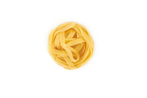Uncooked nest of tagliatelle pasta isolated on white background. — Stock Photo, Image