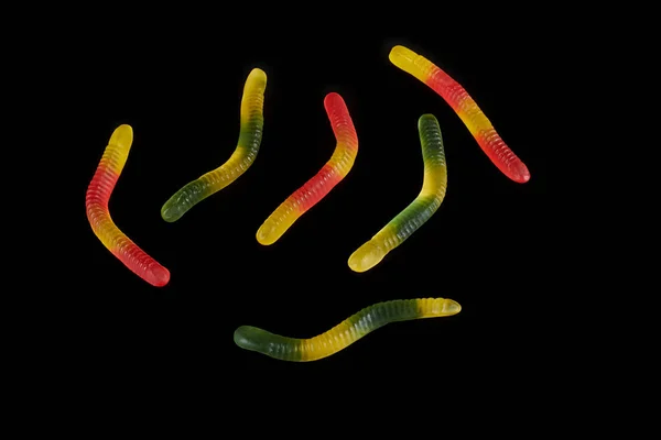 Gummy jelly worm candy on a black background. — Stock Photo, Image