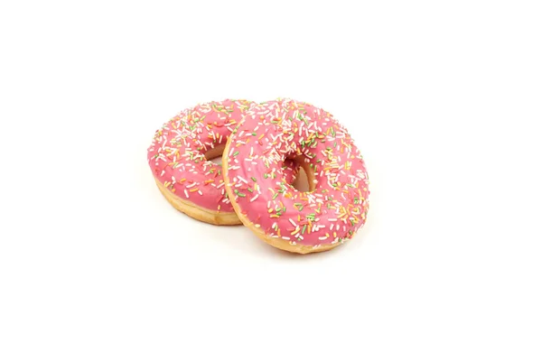 Rosado donut con coloridos espolvoreos aislados sobre fondo blanco. — Foto de Stock