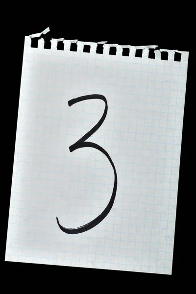 the numbers drawn on a piece of paper on a black background. isolated