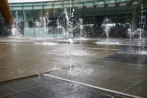 jets of the fountain fall on the stone floor
