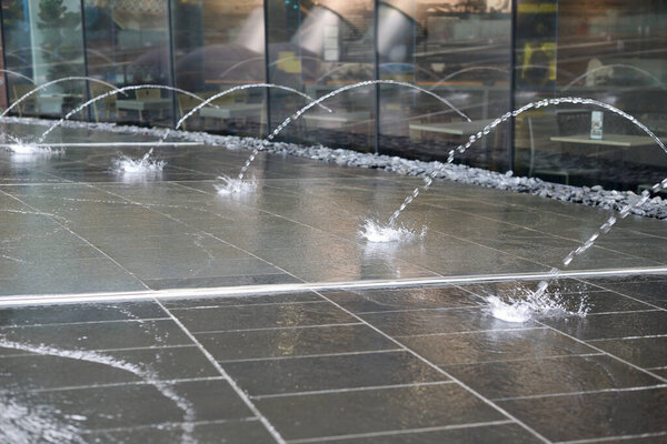 jets of the fountain fall on the stone floor