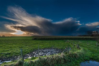 Threatening clouds in the western skies clipart