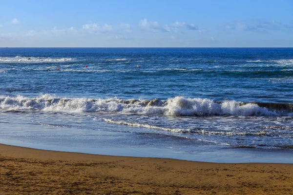 Picturesque waves of a surf at the coast of the Atlantic Ocean in cloudy weather