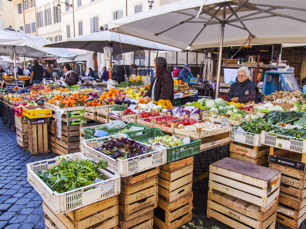 ROME, ITALY, on March 11, 2017. Various vegetables and fruit are laid out on market counters at Campo Di Fiori Square