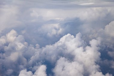 Gökyüzü ve pitoresk bulutlar büyük yükseklikte uçan uçak penceresinden görünümü