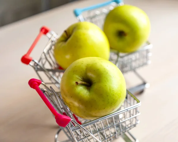 Three Green Fresh Tasty Apples Store Carts — Stock Photo, Image