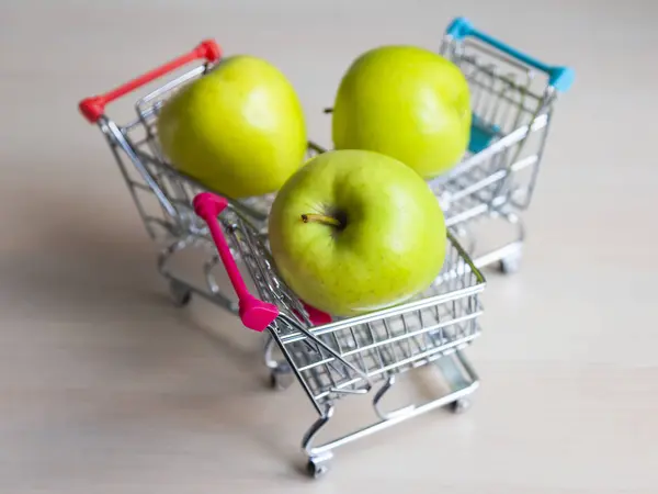 Three Green Fresh Tasty Apples Store Carts — Stock Photo, Image