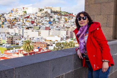 Las-Palmas de Gran Canaria, Spain, on January 10, 2018. The attractive woman admires a view of the city from the survey platform of a cathedral clipart