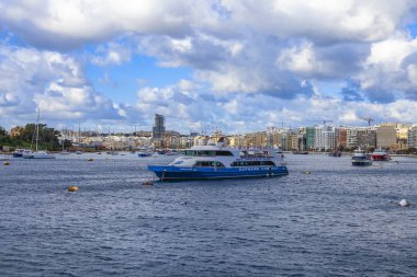 Sliema, Malta, üzerinde 8 Ocak 2019. Pitoresk koyda yürüyen Tekneler güneşin ile kış sabahları yanıyor. Uzaktan güzel dolgu