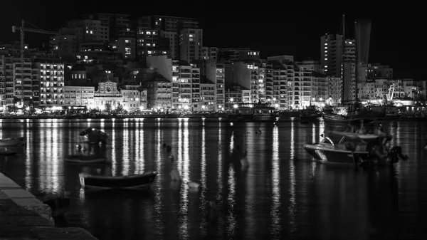 Sliema, Malta, on January 5, 2019. Night look. the picturesque embankment of the bay lit with evening fires which are reflected in bay water