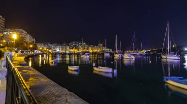 Sliema, Malta, 5 Ocak 2019 tarihinde. Gece bak. defne suya yansıyan akşam yangınlar ile Bay pitoresk setin yaktı