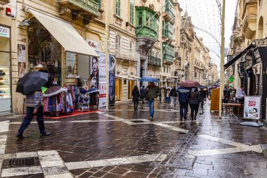 Valletta, Malta, üzerinde 8 Ocak 2019. İnsanlar Cumhuriyet Caddesi üzerinde bir yağmur sırasında gitmek.