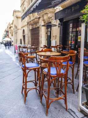 Valletta, Malta, üzerinde 8 Ocak 2019. İnsanlar eski şehrin yoğun alışveriş caddesi boyunca gidin. Masalara sokak Cafe ziyaretçiler için