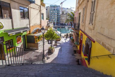 San Giljan, Malta, 5 Ocak 2019 tarihinde. denize iletken bir merdiven ile pitoresk sokak
