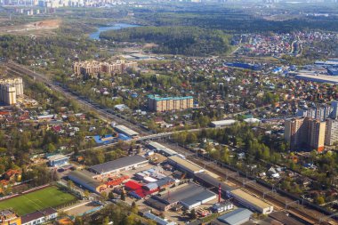 Büyük yükseklikte uçan uçağın penceresinden kara yüzeyinin ve çok katlı binaların görünümü