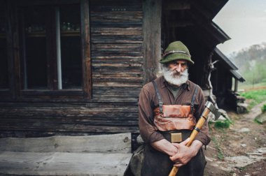 Portre eski ahşap kulübe yakın balta ile forester sakallı