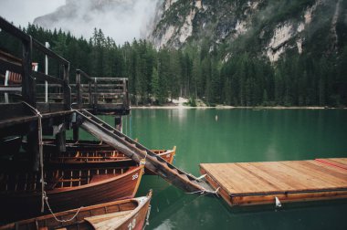 picturesque view of Pragser Wildsee Lake and wooden pier, Prags Dolomites in South Tyrol, Italy  clipart