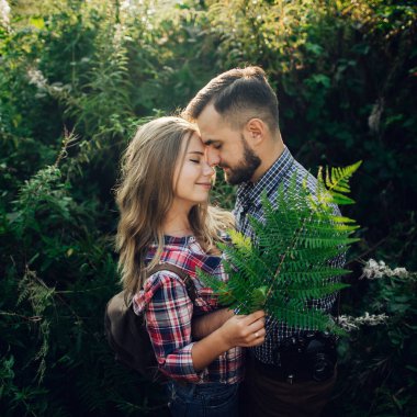 Yeşil park günbatımında sarılma ihale genç Çift 