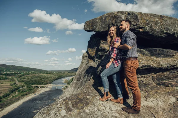 Portrait of happy young couple in mountain landscape