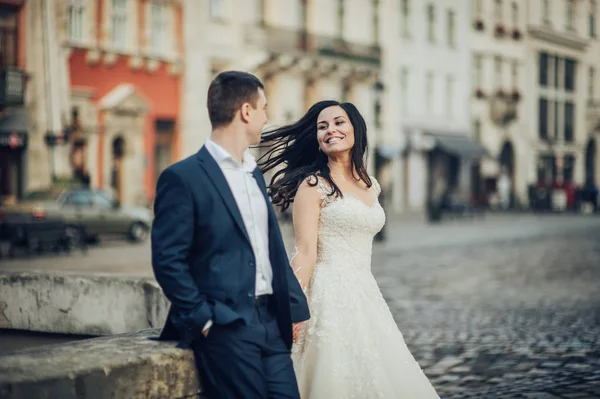 都市の広場で楽しみを持っている幸せな新婚カップル — ストック写真