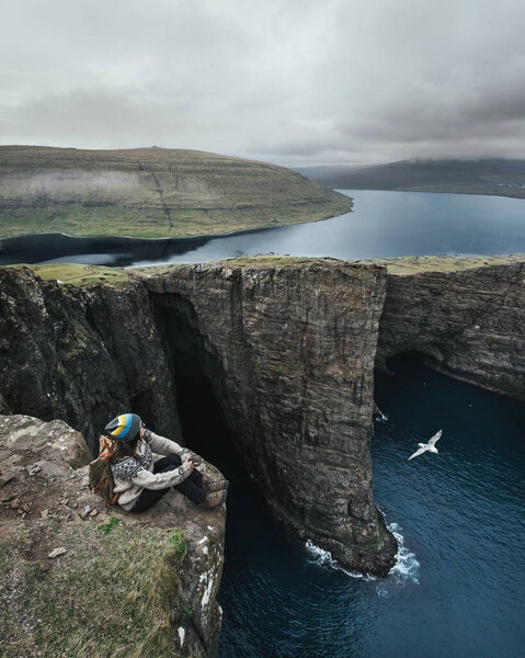Traveler Backpack Sits Cliff Beautiful View Fjord Faroe Islands Wonder Stock Photo