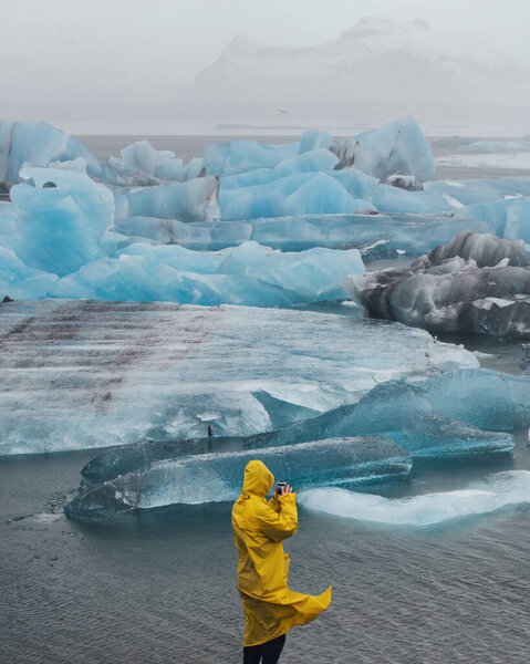 Man Background Large Blue Icebergs Arctic Traveler Yellow Raincoat Background Stock Image