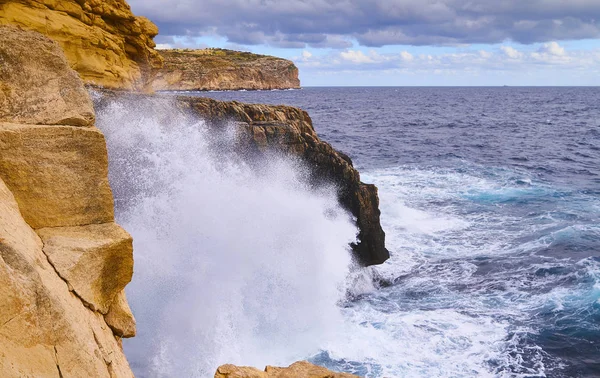 Huge waves crash on cloudy day. Kemmuna island