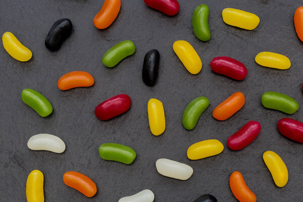 Jelly beans candy sweets abstract dark food background