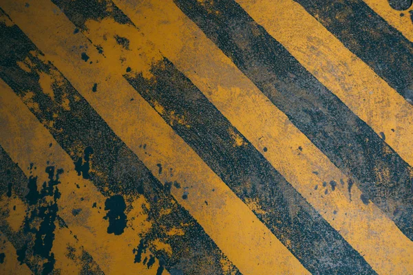 Dirty yellow diagonal warning lines background for construction danger