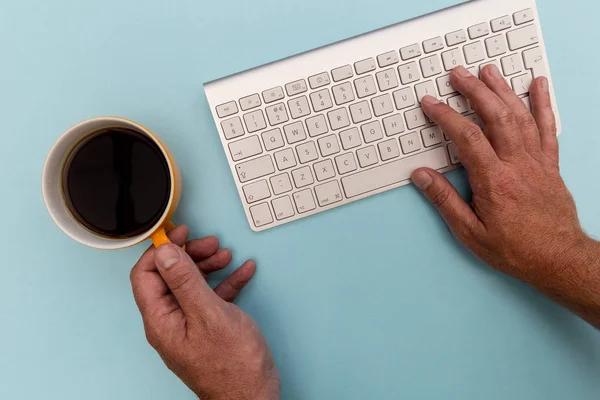 Minimal office workplace view. Computer keyboard on bright blue background