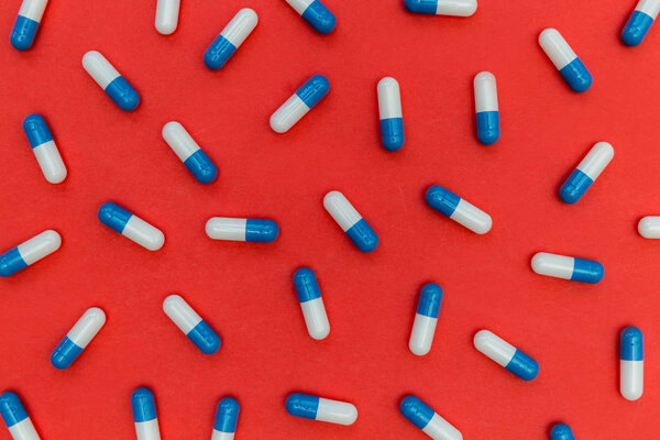 close-up view of pills on bright red background