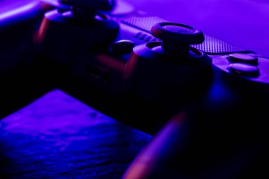 Detail view of video game controller at night with lights clipart