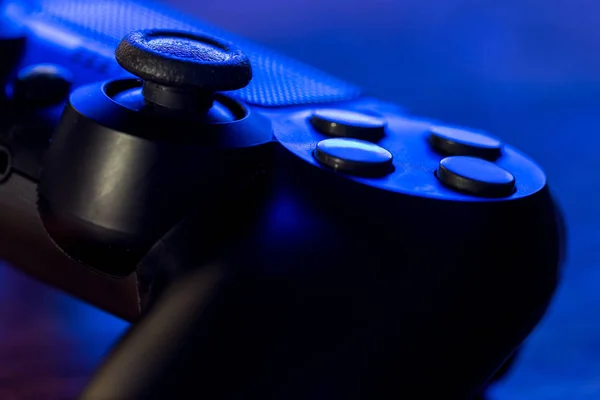 Detail view of video game controller at night with lights