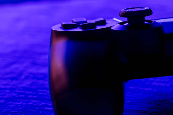 Detail view of video game controller at night with lights