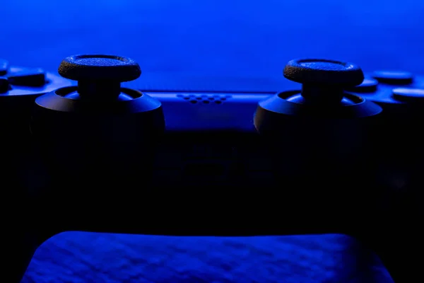 Detail view of video game controller at night with lights