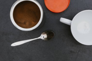 Koyu arka plan üzerinde beyaz bardak ve kaşık hazır kahve küp görünümü Kapat