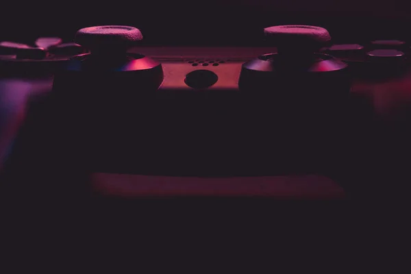 Close up of video game controller with lights