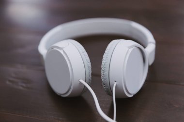 Ahşap masa masa üzerinde beyaz müzik kulaklık