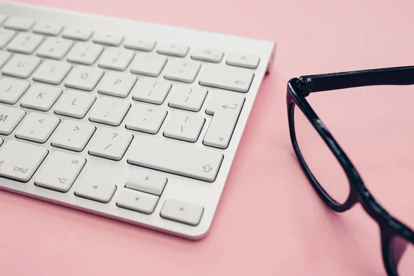 Computer keyboard glasses minimal home office bright pink color